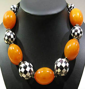 Something Special necklace with chess patterned mother of pearl & orange bakelite: US$950.