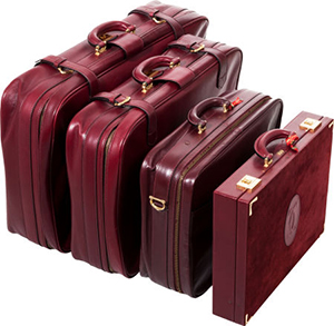 Cartier set of four: burgundy leather & suede luggage set.