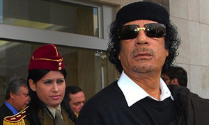 Colonel Qaddafi likes wearing sunglasses.