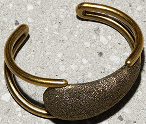 Tomas Maier women's brass cuff with sparked brass nugget focal point: US$490.