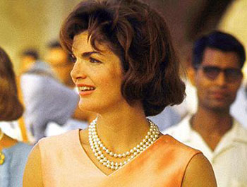 Jackie Kennedy Onassis wearing the three strand set of simulated pearl necklace which sold for over £50,000.