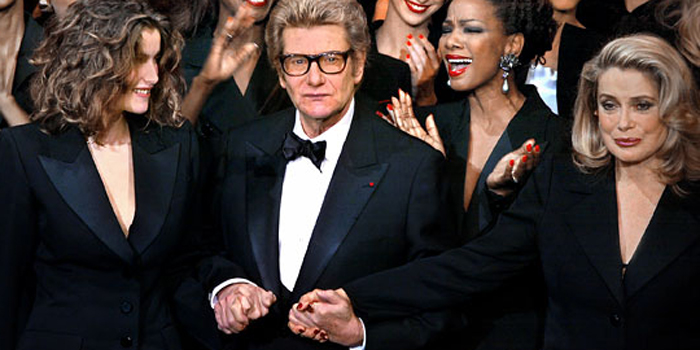 Yves Saint Laurent (1936-2008) at fashion show (January 2002) with friend and muse Catherine Deneuve, and models.
