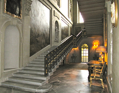 Easton Neston main staircase, with its wrought iron balustrade in the style of Jean Tijou, comprises two long, shallow flights ascending to the first floor gallery which is decorated with grisailles painted by Sir James Thornhill.