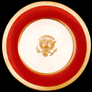 The Reagan state china service was modeled on Woodrow Wilson's china and features the seal of the president of the United States in burnished gold on an ivory background with a border of scarlet. The china was manufactured in the United States by Lenox, and selected by First Lady Nancy Reagan.